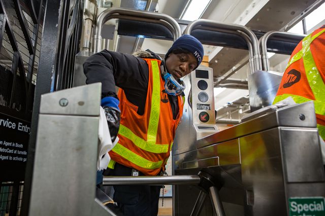 MTA transit workers clean a subway station in Brooklyn as well as a subway car.